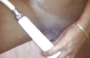 A Pakistani chick playing with a shower head on her pussy